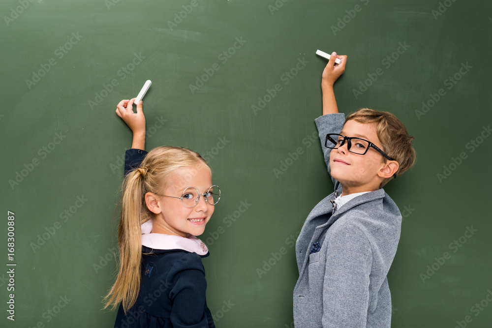 pupils writing on chalkboard