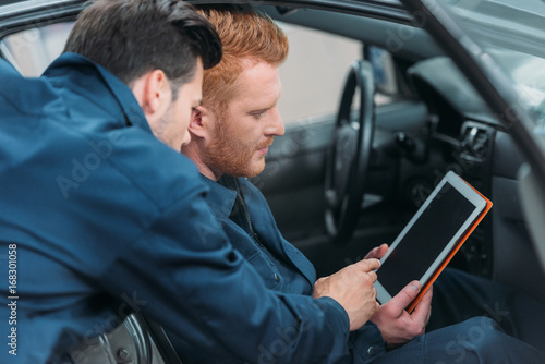 Car mechanics using digital tablet