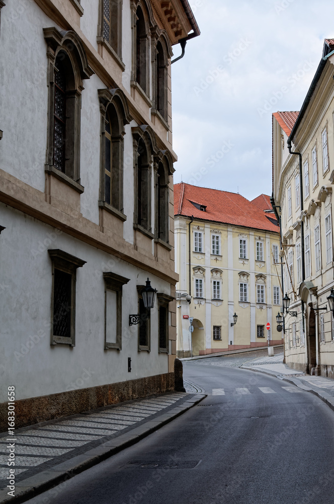 Czech Republic, Prague. Street between old tenements houses with red tiles.