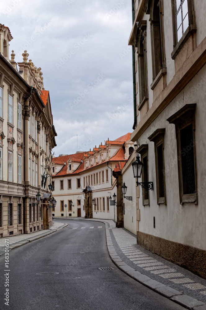 Czech Republic, Prague. Street between old tenements houses with red tiles.