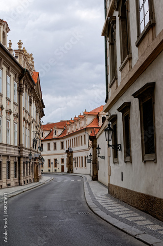Czech Republic  Prague. Street between old tenements houses with red tiles.