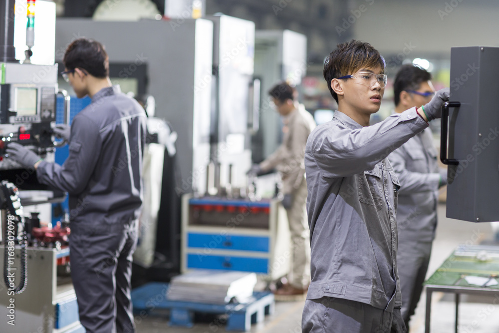 Confident engineers working in the factory Confident engineers working in the factory