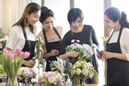 Young women learning flower arrangement photo