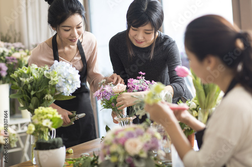 Young women learning flower arrangement photo