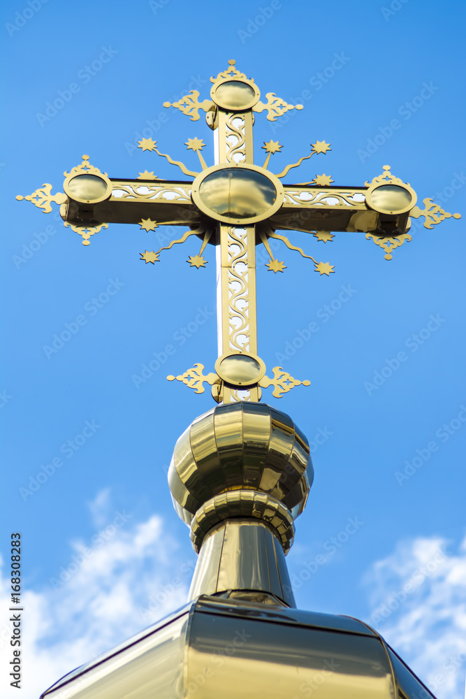 Orthodox cross on a background of summer sky and clouds