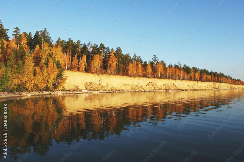 Panoramic landscape with river and autumn forest on the high Bank.