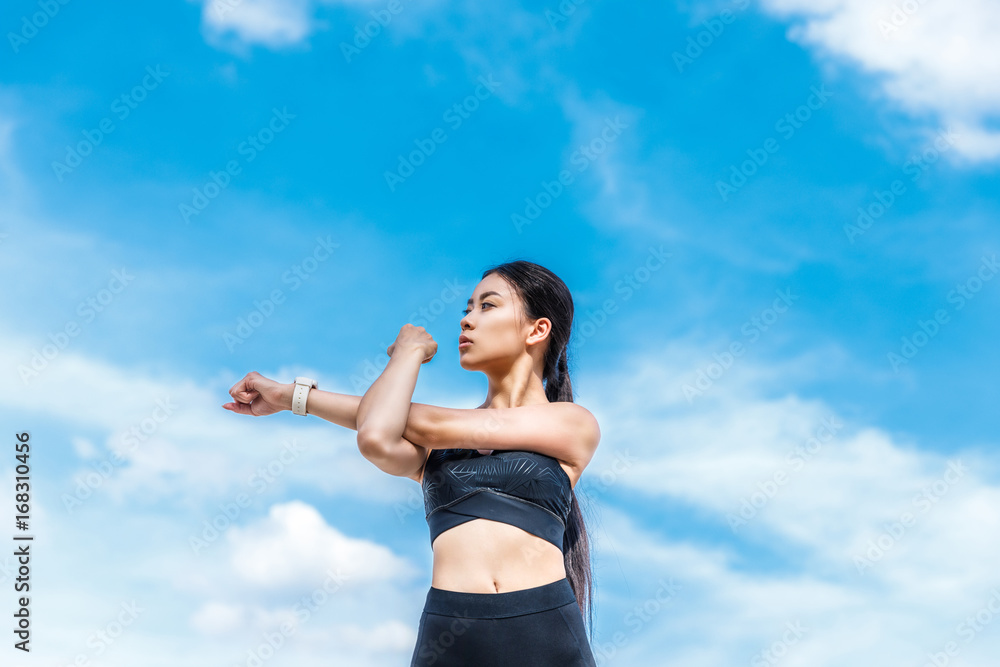 sportswoman stretching hands