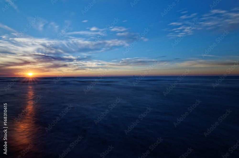 Sunset over sea. Colorful sky and waves at sea. Poland, Jastrzebia Gora