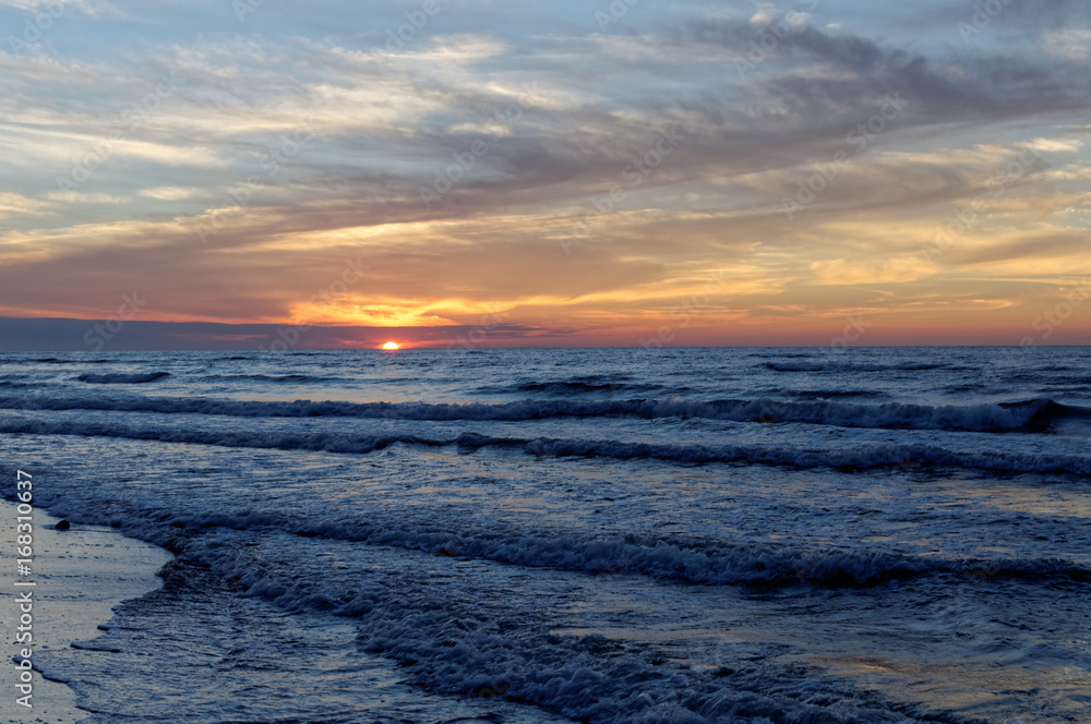 Sunset over sea. Colorful sky and waves at sea. Poland, Jastrzebia Gora