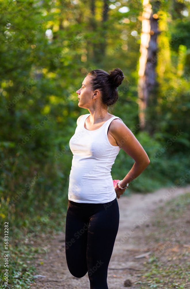 Beautiful tall fitness model working out in the woods Beautiful tall fitness model working out in the woods