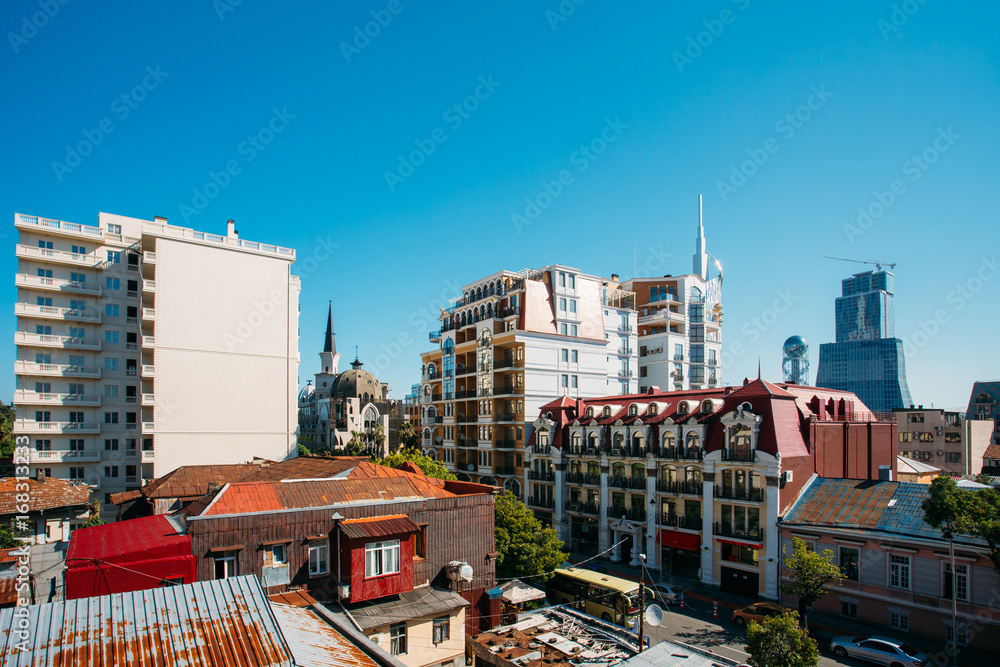 Fototapeta premium Modern Houses Rise Above The Old Rusty Roofs In Batumi, Adjara Georgia