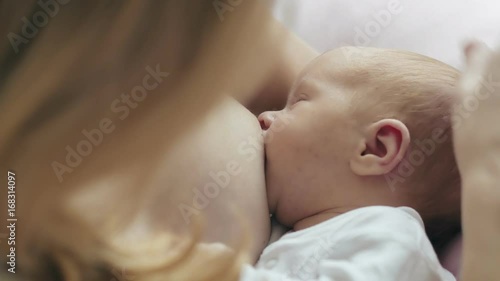 Young mother breastfeeding a newborn baby. Mom and baby photo