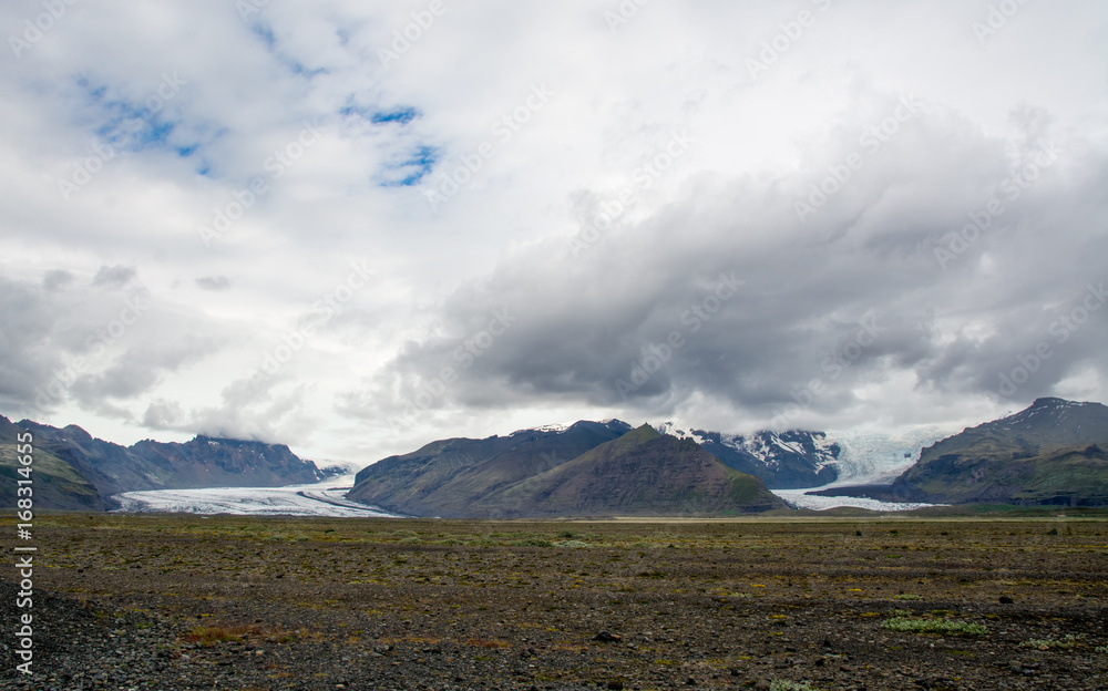 Beautiful mountains and dramatic sky along the road in Iceland Beautiful mountains and dramatic sky along the road in Iceland
