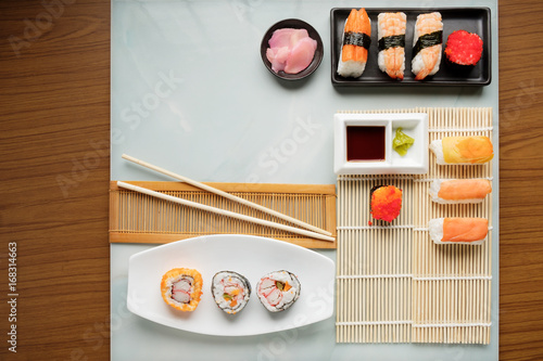 Sushi set / View of japanese food on light blue tile. Sushi set. Top view.