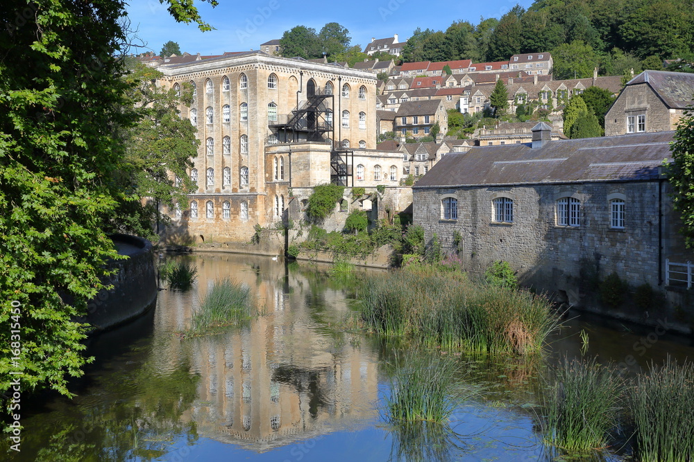 View of Abbey Mill building on river Avon with Tory neighborhood in the background, Bradford on Avon, UK