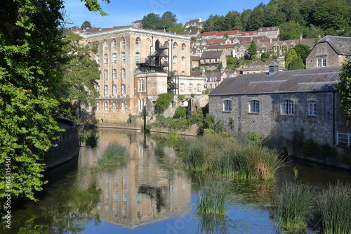 View of Abbey Mill building on river Avon with Tory neighborhood in the background, Bradford on Avon, UK