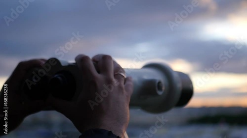 Holding binoculars in hands on sunset background, close-up. slow motion, 1920x1080, full hd