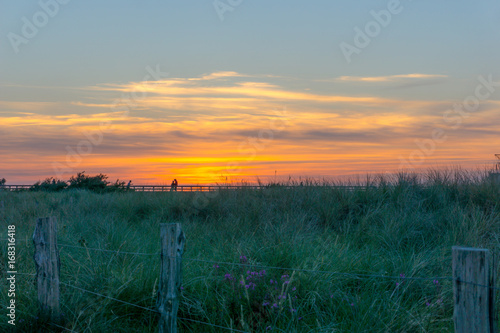 sunset behind the dunes, baltic sea