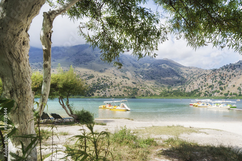 People on the boats on the mountain lake kournas on Crete.