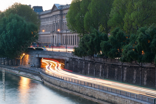 Car light trails at a tunnel exit on the river Seine borders in Paris, France photo