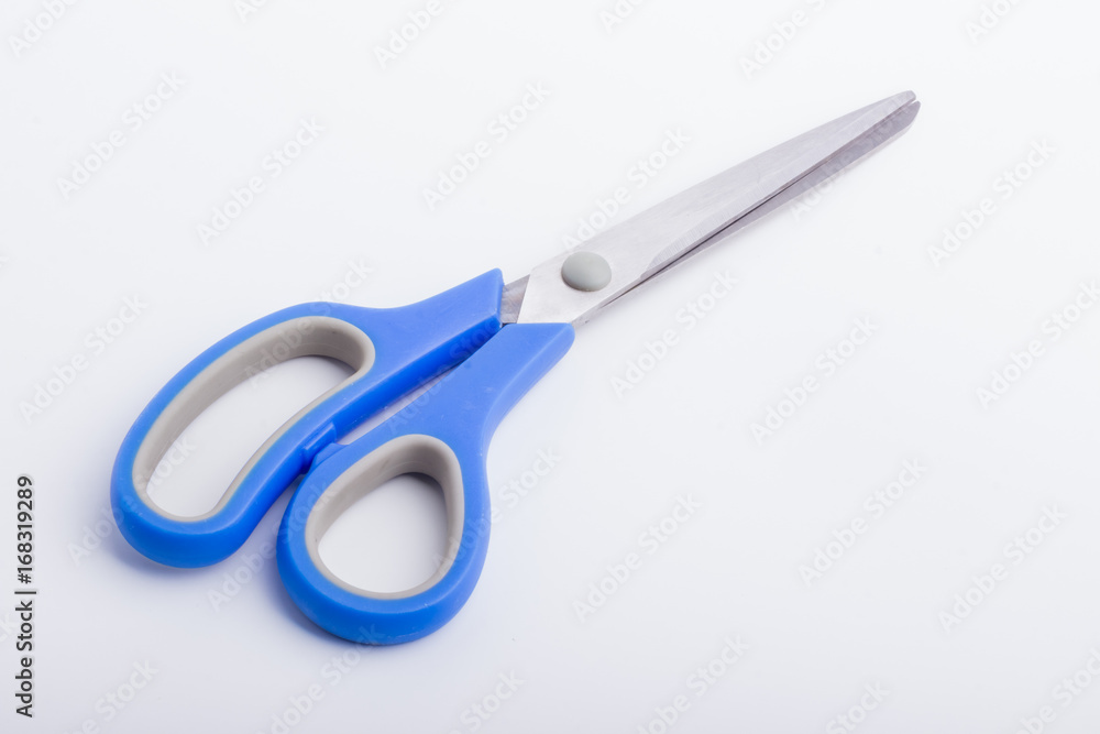 A closed pair of scissors with a blue grip A closed pair of scissors with a blue grip
