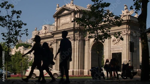 Silhouettes of pedestrians to Alcala gate, a famous tourist landmark in Madrid