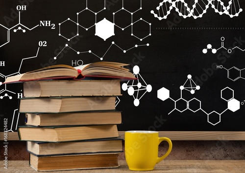Books on Desk foreground with blackboard graphics of science for