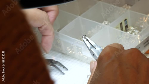 jewelry handmade by experienced woman with tools in her studio
