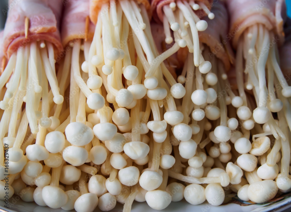 closed up the bacon wrapped Golden Needle Mushroom in a plate closed up the bacon wrapped Golden Needle Mushroom in a plate