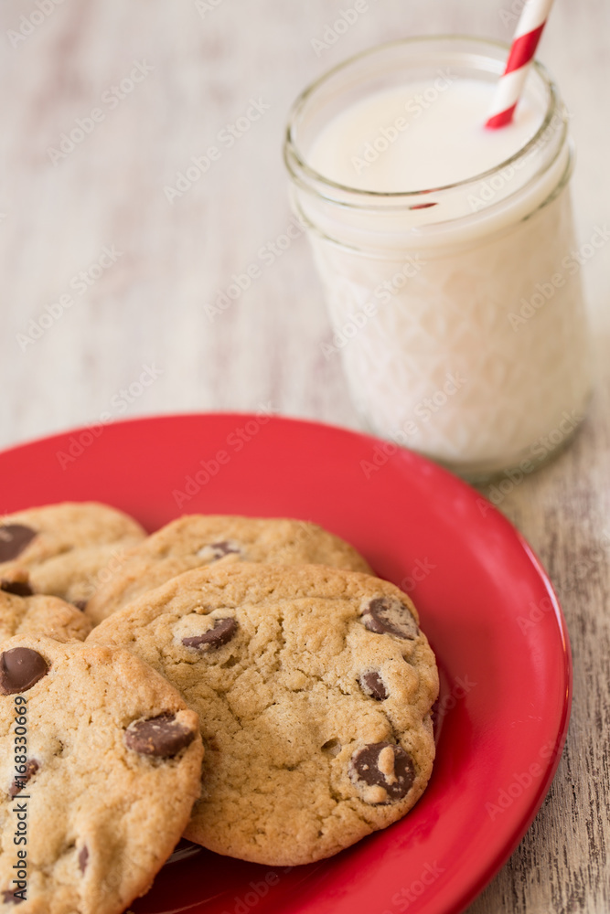 Chocolate Chip Cookies and Milk on Red Plate Chocolate Chip Cookies and Milk on Red Plate
