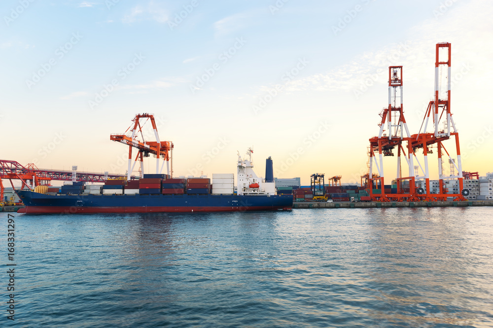 The transport vessel is parked at the pier at sunset in Japan.