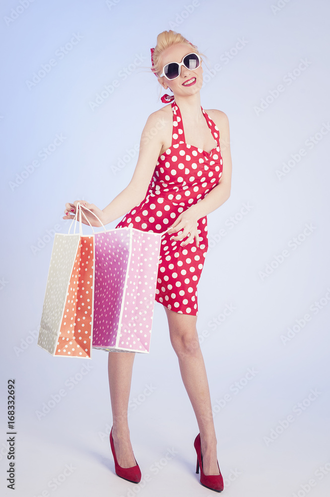 Retro pin up girl shopping. Woman holding paper bag Retro pin up girl shopping. Woman holding paper bag