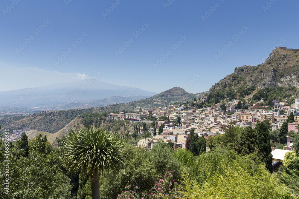 The town of Taormina in Sicily with the mount Etna in the background