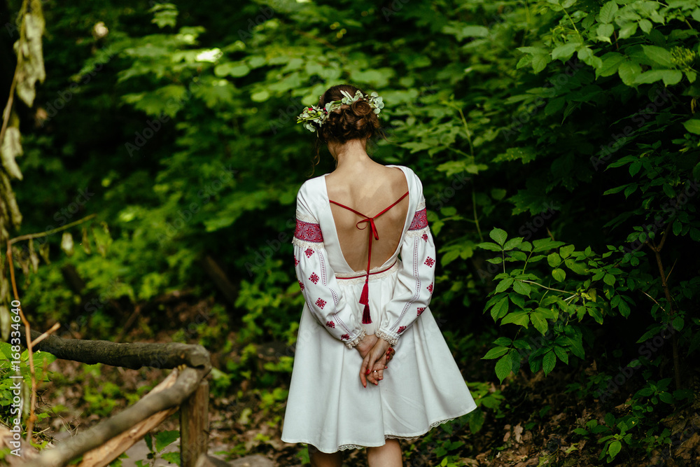 Back view of bride in national dress with a wreath on her head. Ukrainian folklor wedding, culture, ethical traditions, concept. Back view of bride in national dress with a wreath on her head. Ukrainian folklor wedding, culture, ethical traditions, concept.