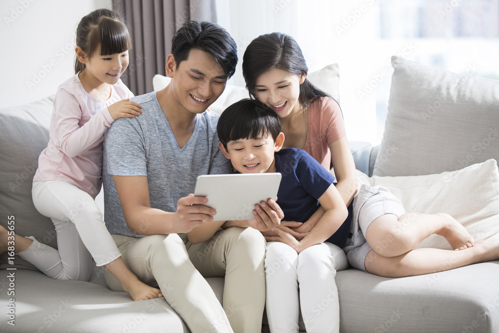 Happy young family using digital tablet at home Happy young family using digital tablet at home