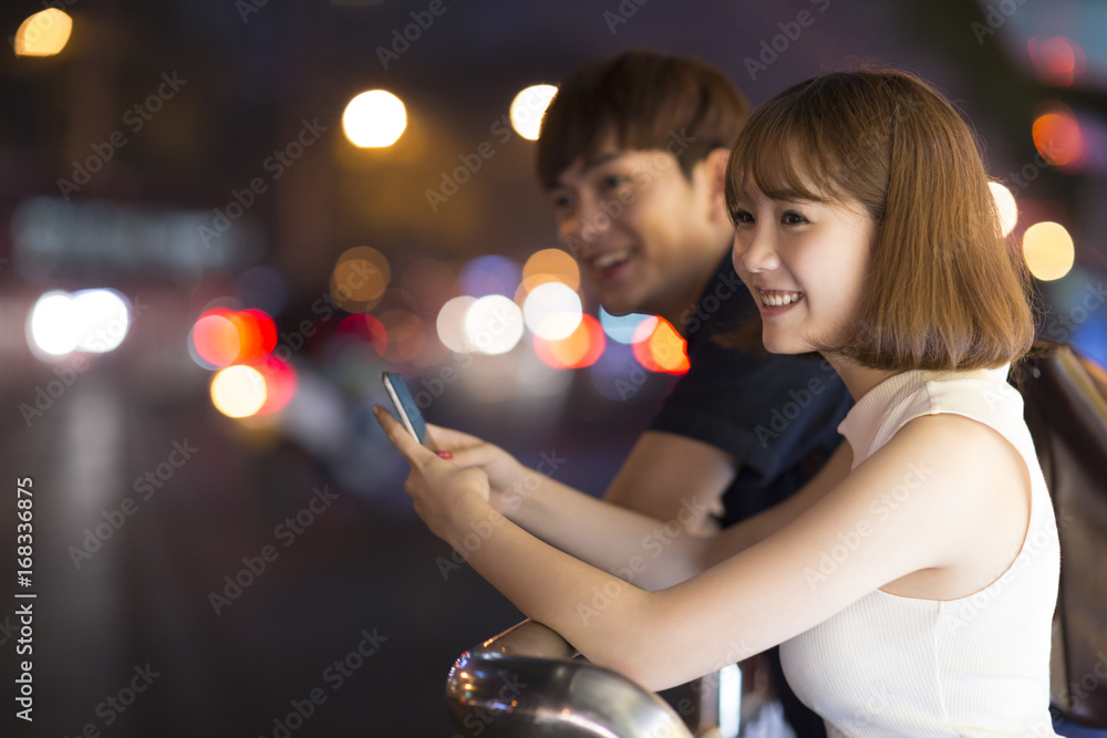 Young couple waiting at the bus stop Young couple waiting at the bus stop