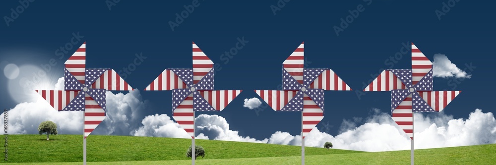 USA wind catchers in front of grass and sky