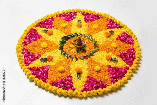 Photos flower rangoli for Diwali or pongal made using marigold or zendu flowers and red