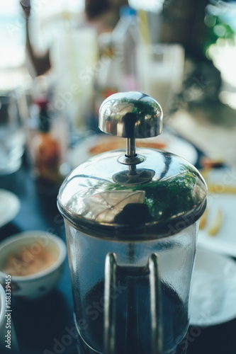 French press coffee maker in a cafe bar. close up image toned image selective focus photo