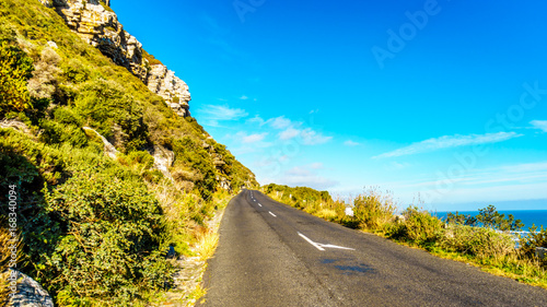 The road to Chapman's Peak along the Atlantic coast at the Slangkop Lighthouse near the village of Het Kommetjie in the Cape Peninsula of South Africa
