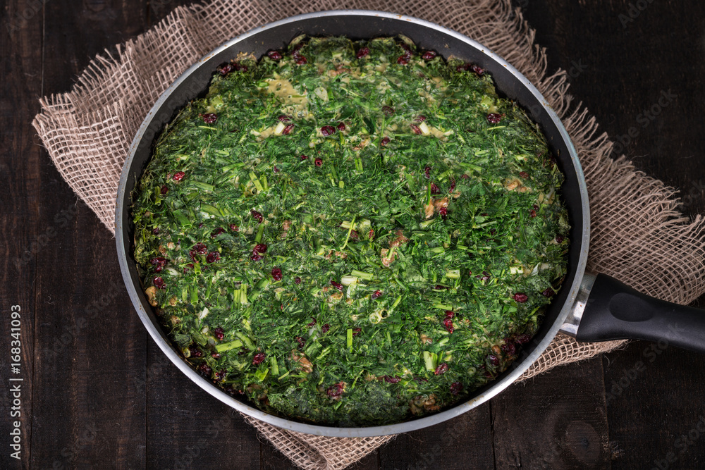 Persian Mixed herbs frittata with barberry and walnut in pan (Kuku and Zereshk) - obrazy, fototapety, plakaty 