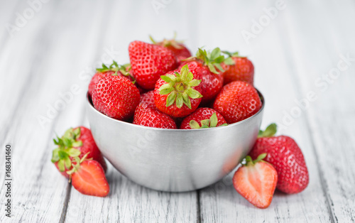 Portion of Strawberries on wooden background  selective focus