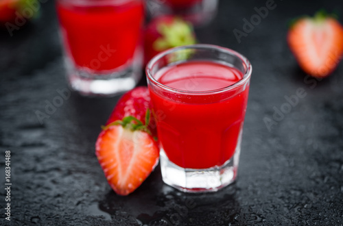 Rustic slate slab with Strawberry liqueur, selective focus