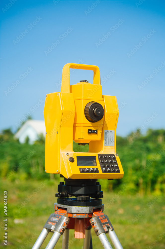 Fototapeta premium Surveyor equipment theodolite on tripod on future construction site