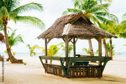Fototapeta Naklejka Na Ścianę i Meble -  Landscape of paradise tropical island with palms cottages and white sand beach