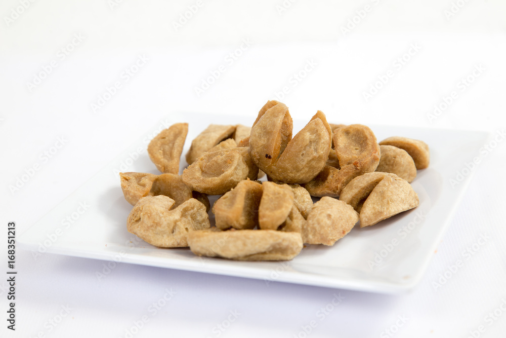 Deep fried meatballs on white plate on a table Deep fried meatballs on white plate on a table