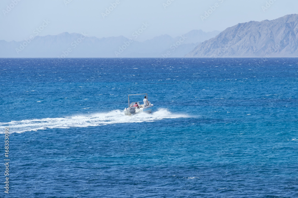 Boat, in the background of the mountains in the Red Sea