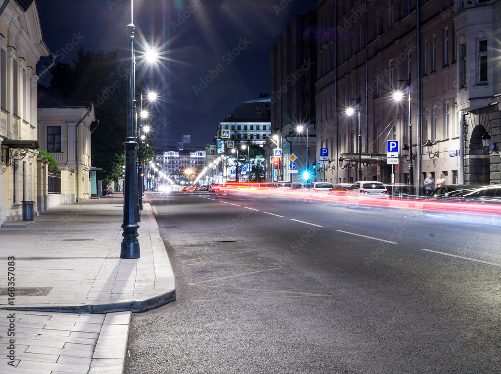 Fototapeta premium modern city street with lights and traffic at night. background, citylife.