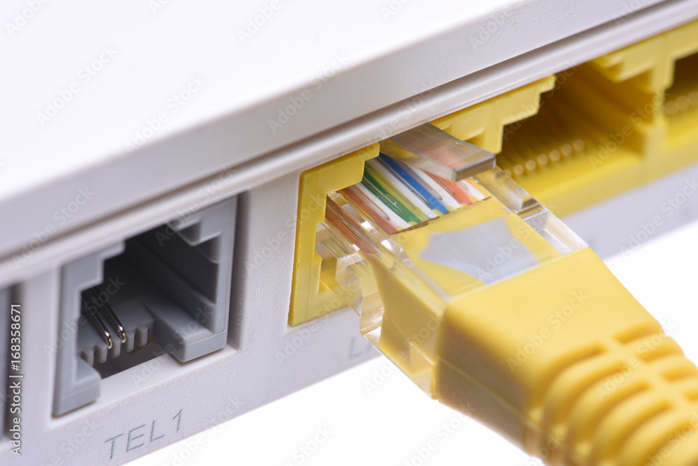 Computer network cable in router closeup, isolated on white background Computer network cable in router closeup, isolated on white background