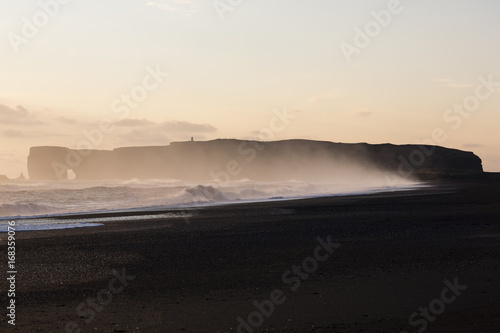 Cape Dirholaey in southern Iceland during sunset on a foggy day